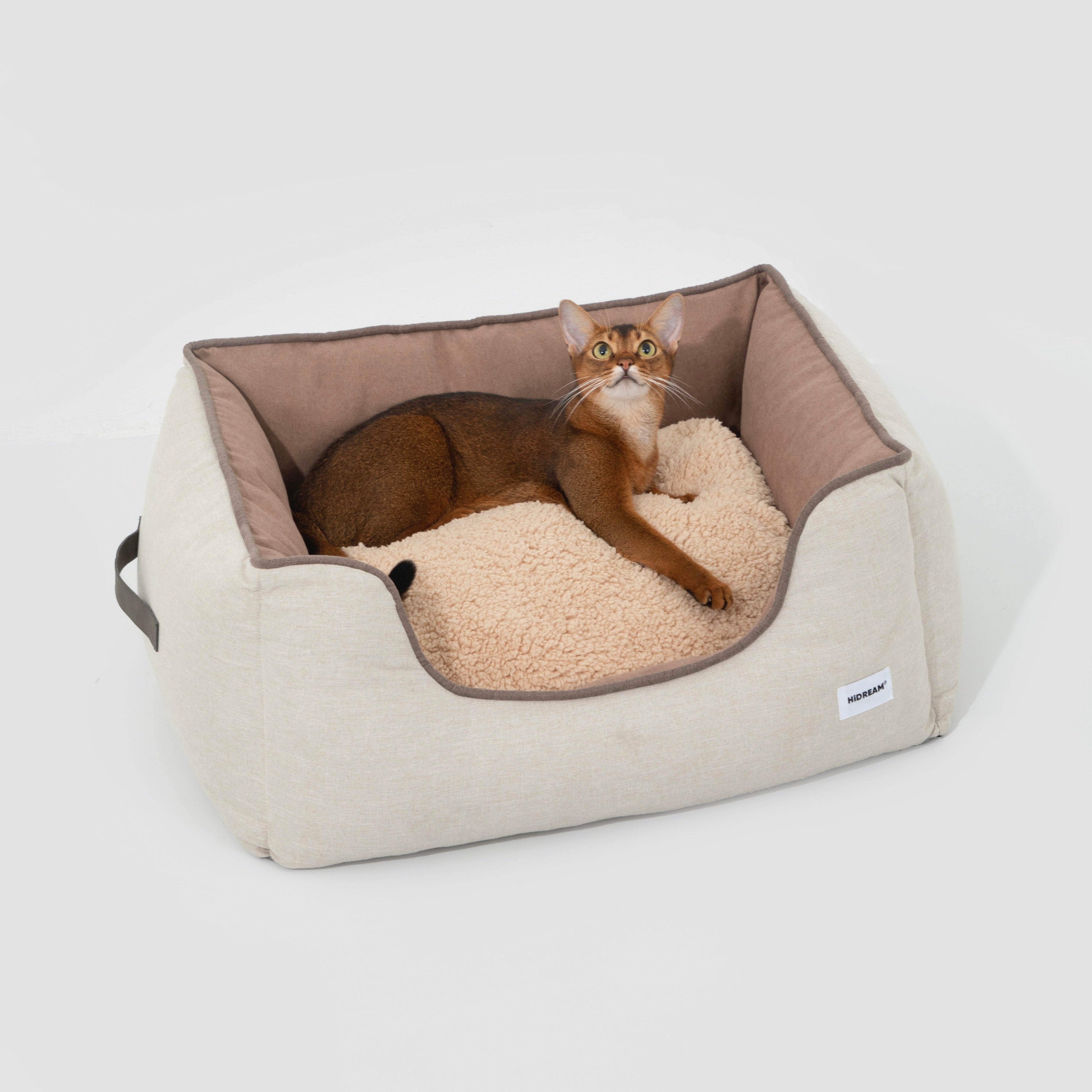 HiDREAM Four-Season Pet Bed with cat lounging on soft beige and brown cushion. Spacious, washable nest ideal for year-round comfort.
