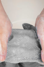 Hands washing HiDREAM Cat Bathing Bag, showing easy-to-clean mesh for hygienic pet grooming use.