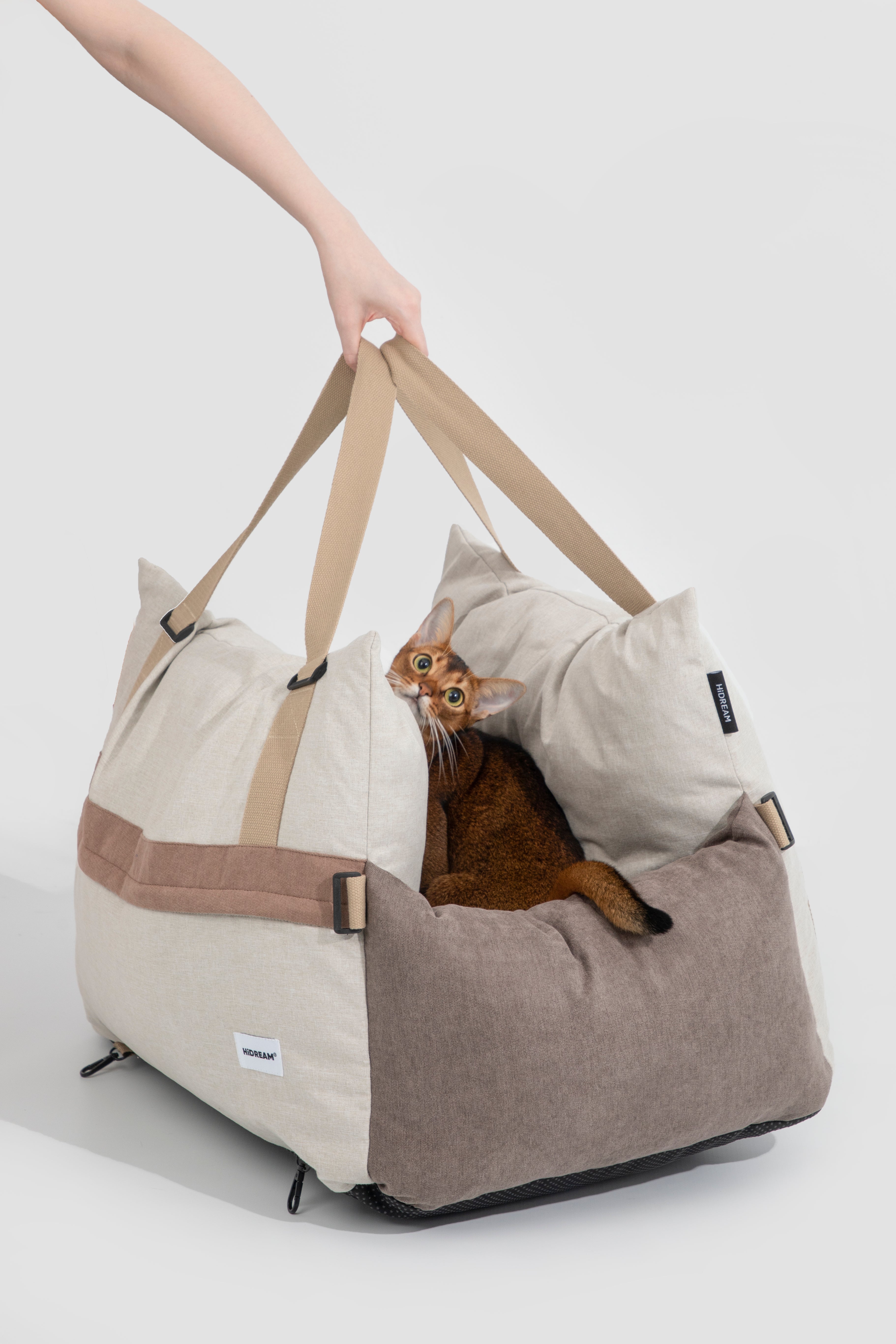 HiDREAM Dog & Cat Car Safety Seat with brown cat inside. Portable and comfy pet bed with carry handles.
