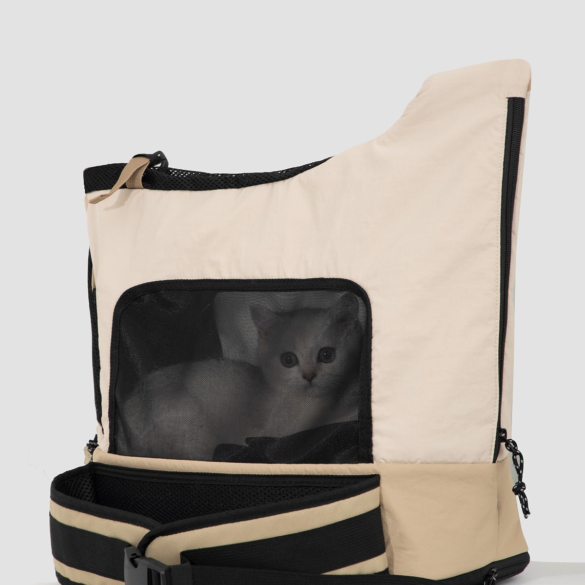 Cat inside beige HiDREAM Crossbody Travel Bag for Pets, visible through mesh window, showing secure and cozy interior.