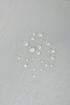 Water droplets on waterproof fabric of HiDREAM Crossbody Pet Carrier Tote. Durable and weather-resistant for outdoor use.