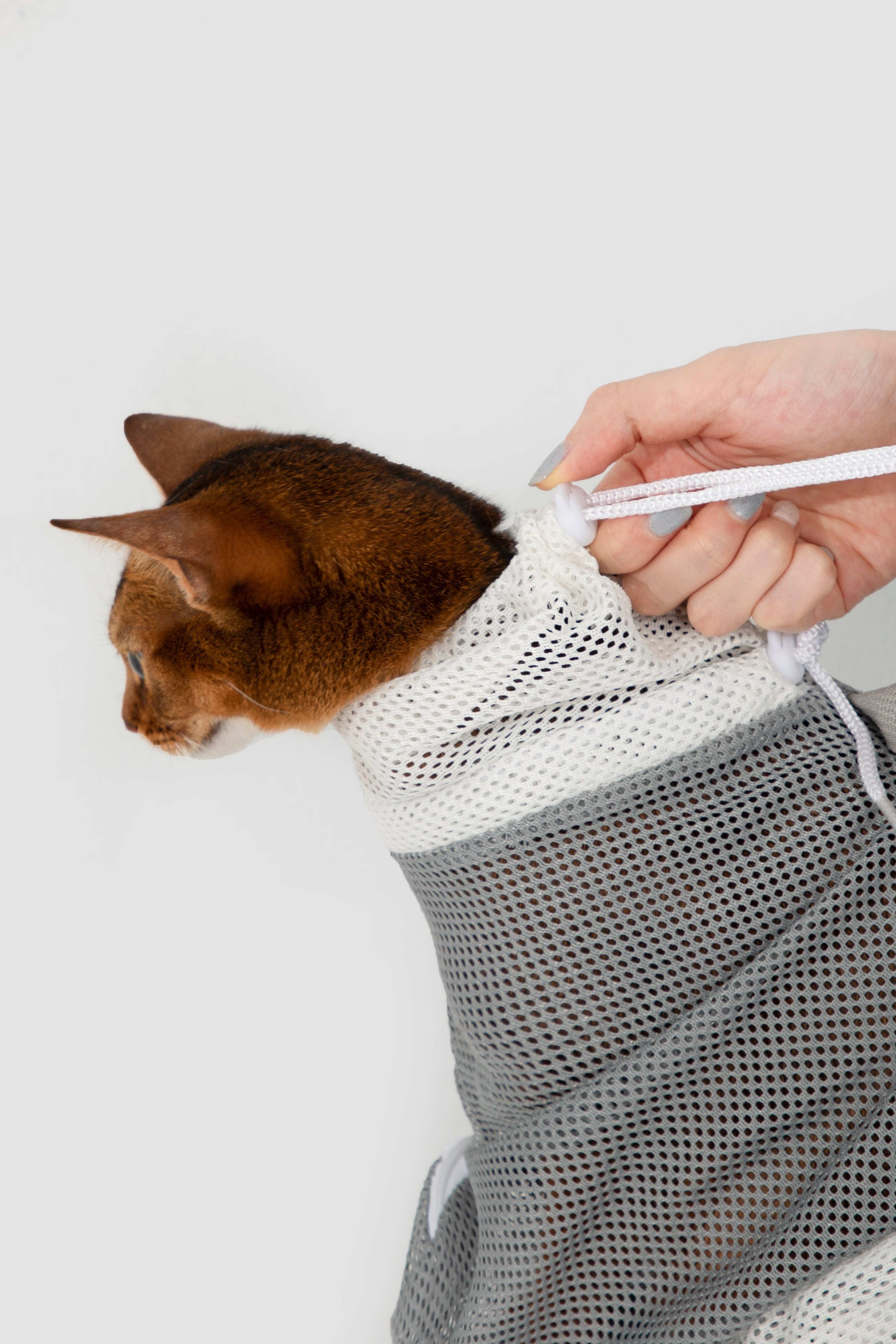 Close-up of HiDREAM Cat Bathing Bag neck drawstring being adjusted for snug and secure fit during grooming.