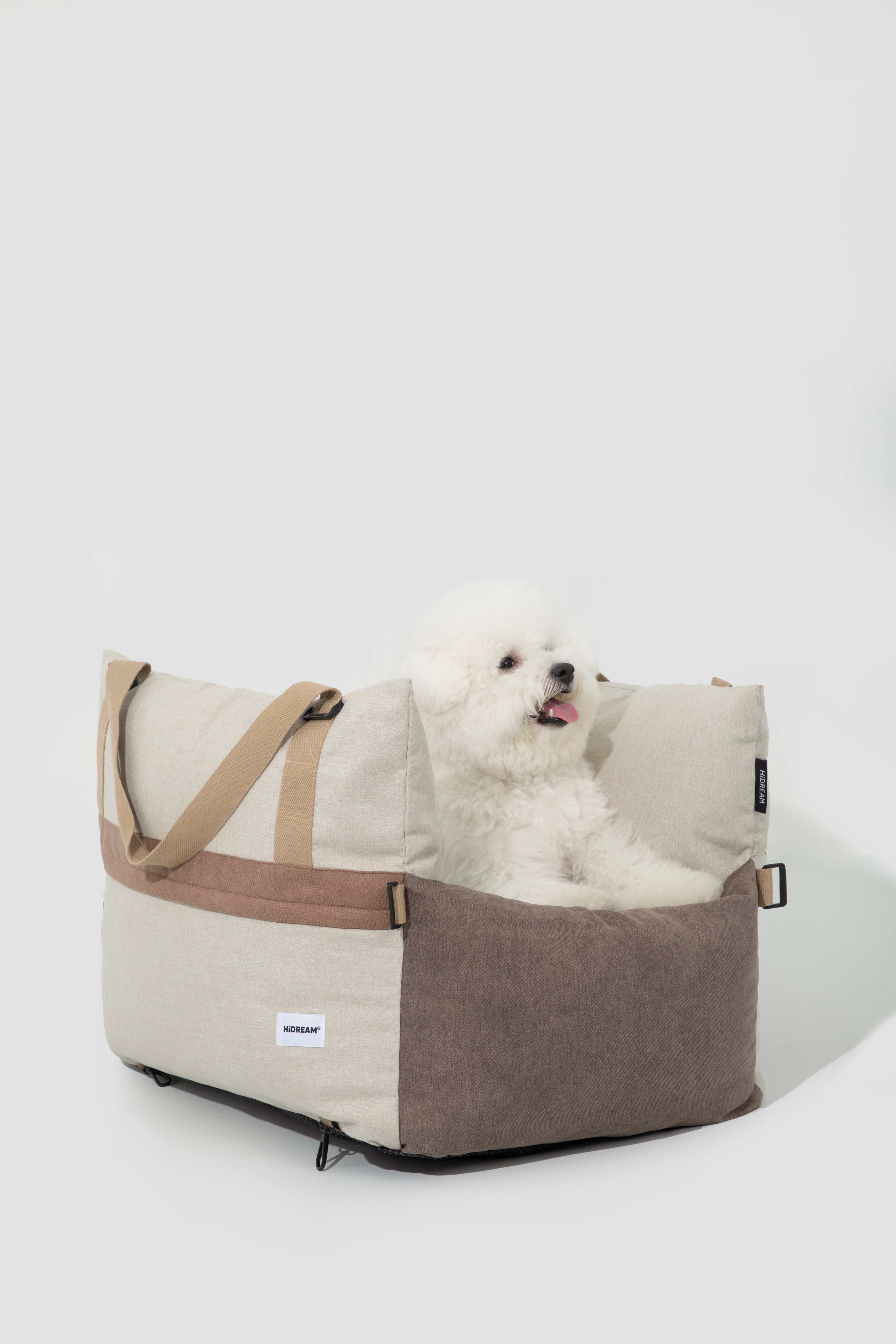 HiDREAM Dog & Cat Car Safety Seat with fluffy white dog lounging inside. Soft, comfy pet travel bed for safe car rides.