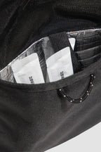 Insulated pocket inside HiDREAM Sling Pet Carrier holding pet treats. A 3-in-1 stylish papoose bag for pet travel in Australia.