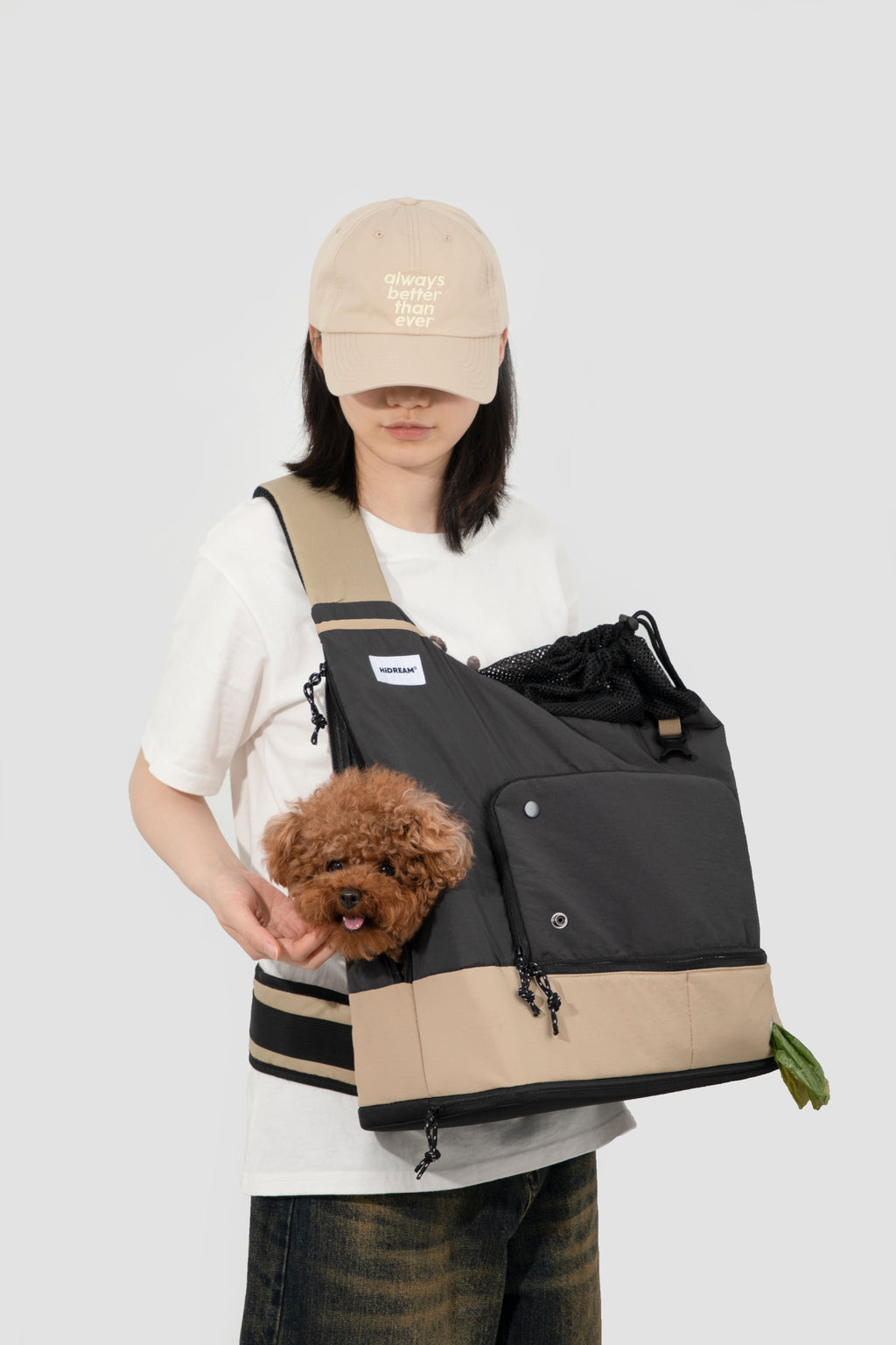 Woman carrying a dog in black HiDREAM Crossbody Travel Bag for Pets, highlighting breathable mesh and escape-proof features.