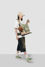 Side view of woman walking with green HiDREAM Crossbody Travel Bag for Pets, ergonomic strap and pet visibility emphasized.