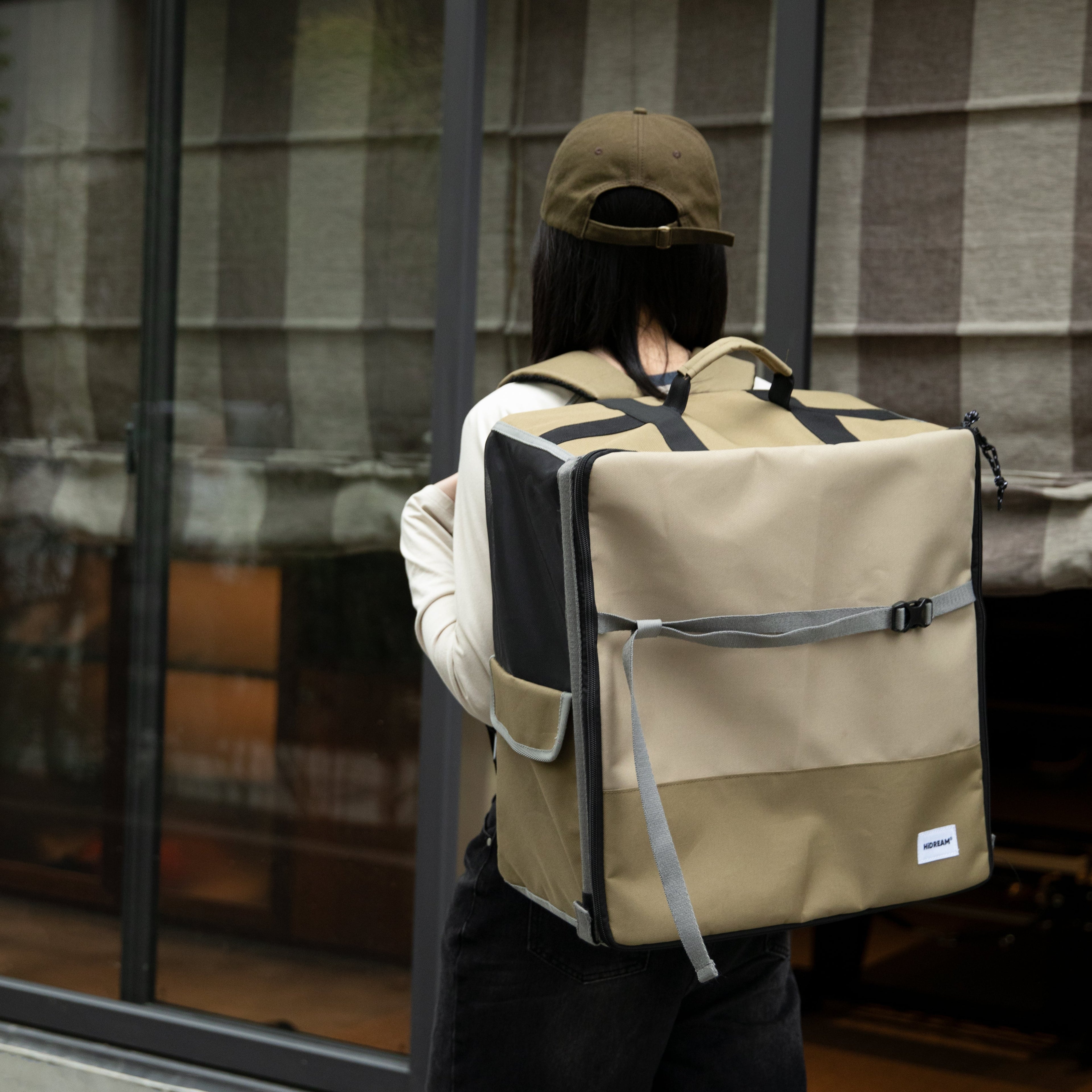 Person wearing HiDREAM Pet Car Seat Backpack – Dual Use Carrier as a backpack, showing its hands-free convenience for pet owners on the go.
