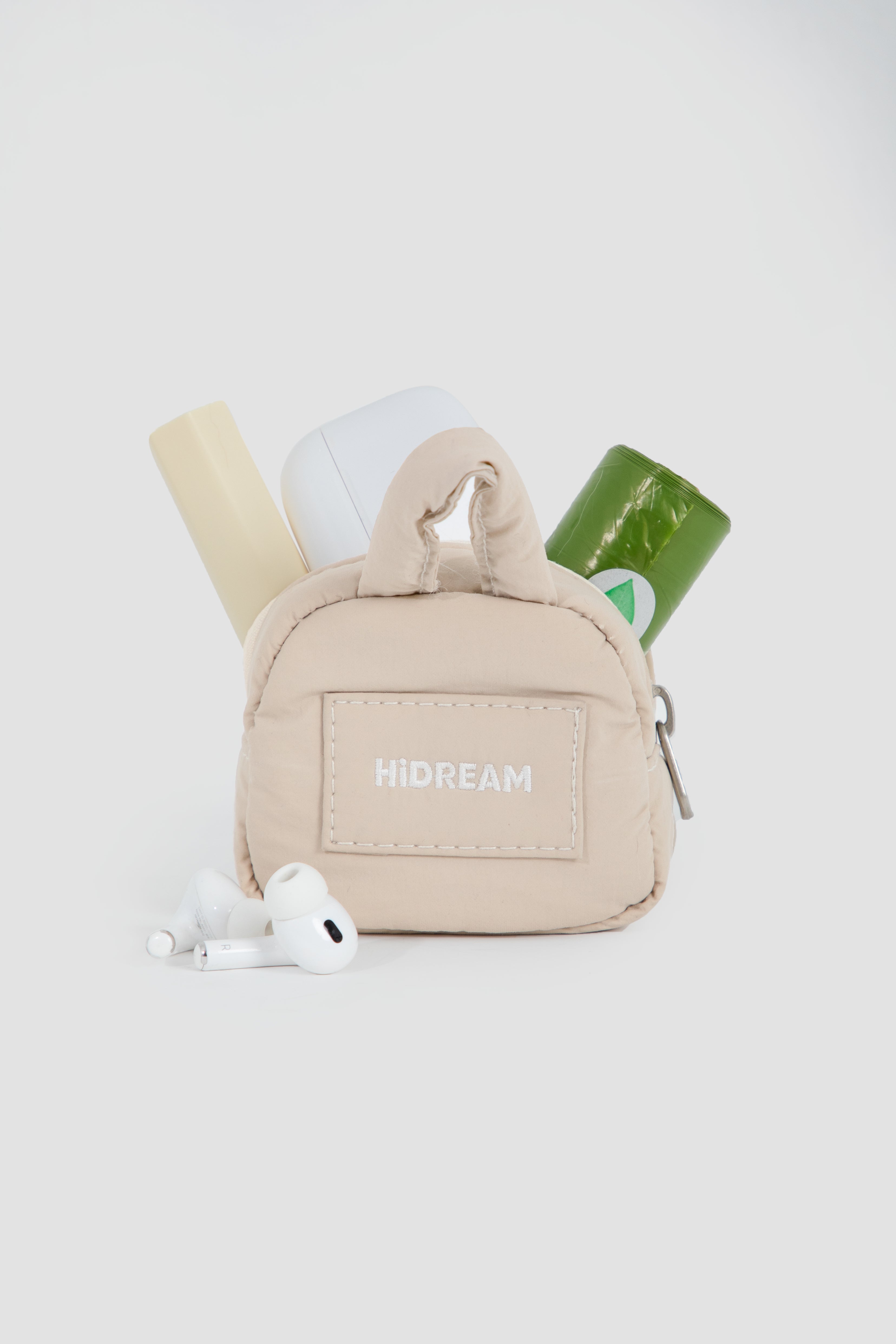 HiDREAM Dog Poop Bag Holder shown with storage for waste bags, earbuds, and essentials, perfect for organized walks.