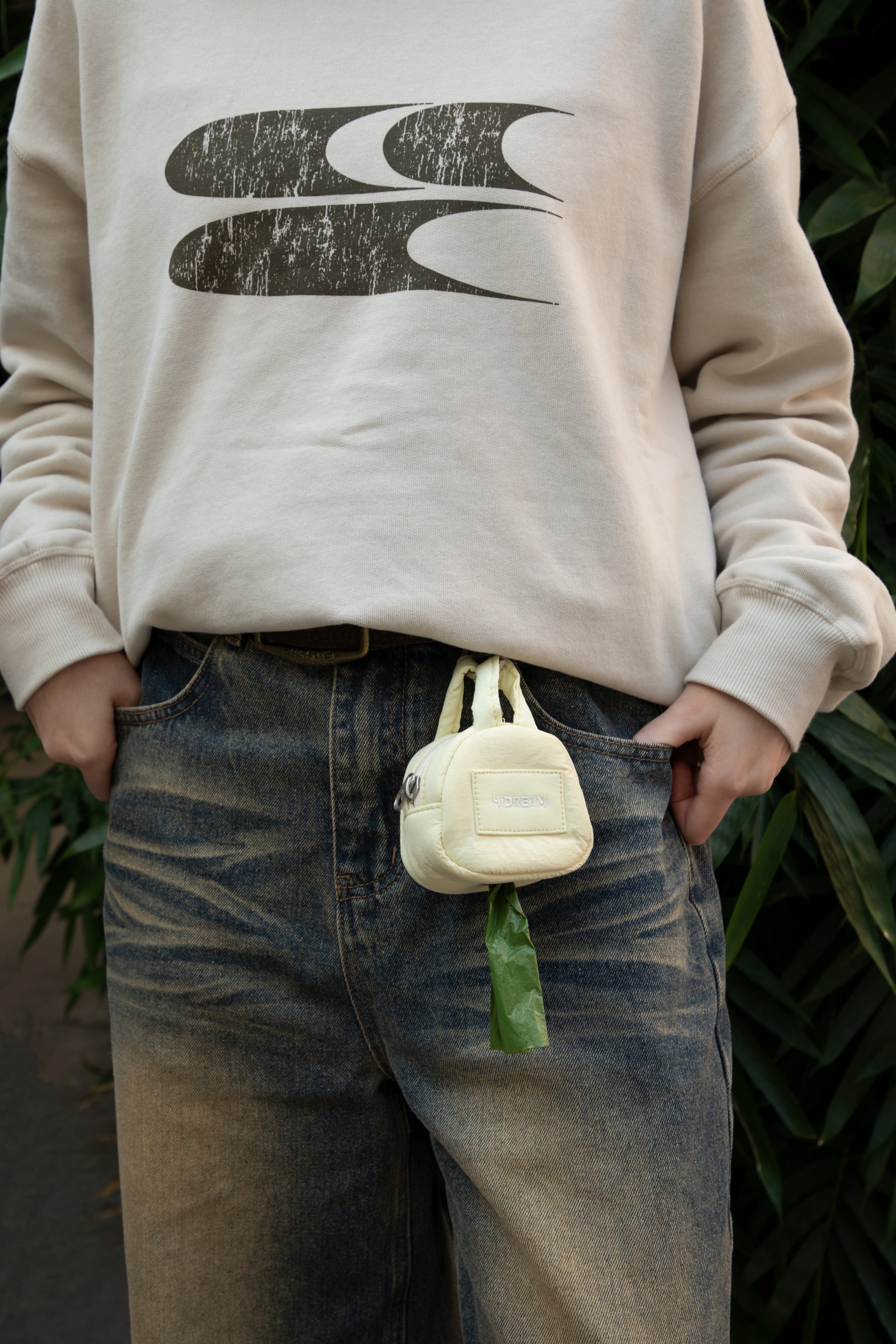 HiDREAM Dog Poop Bag Holder clipped to jeans belt loop, offering hands-free and stylish pet waste solution.