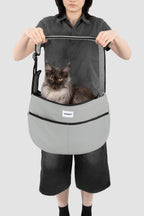 Large grey HiDREAM Crossbody Pet Carrier Tote holding a long-haired cat. Spacious and ergonomic for pet comfort and owner convenience.