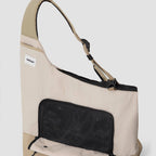 Interior view of beige HiDREAM Crossbody Travel Bag for Pets, showing mesh flap and ergonomic shoulder strap design.