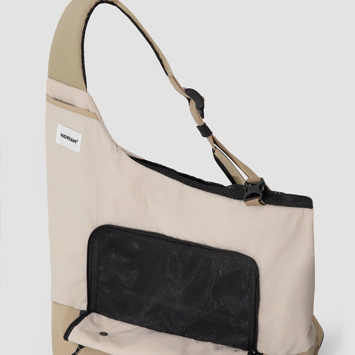 Interior view of beige HiDREAM Crossbody Travel Bag for Pets, showing mesh flap and ergonomic shoulder strap design.