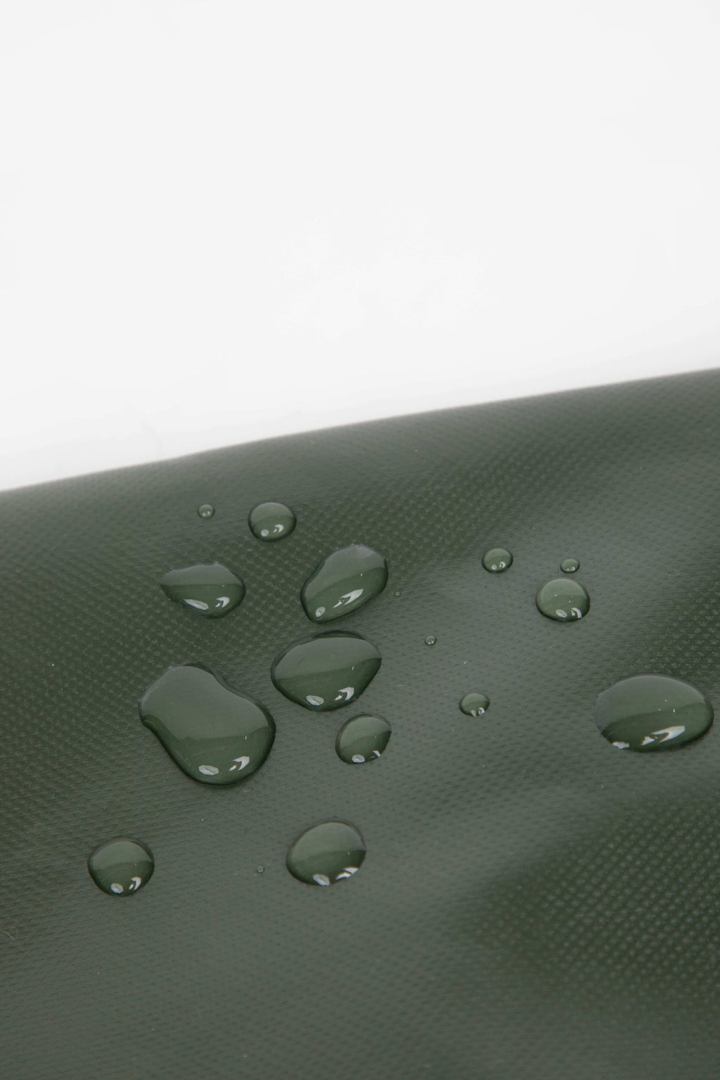 Close-up of water droplets on green HiDREAM Padded Tote Bag, highlighting its water-resistant material for pet safety and durability.