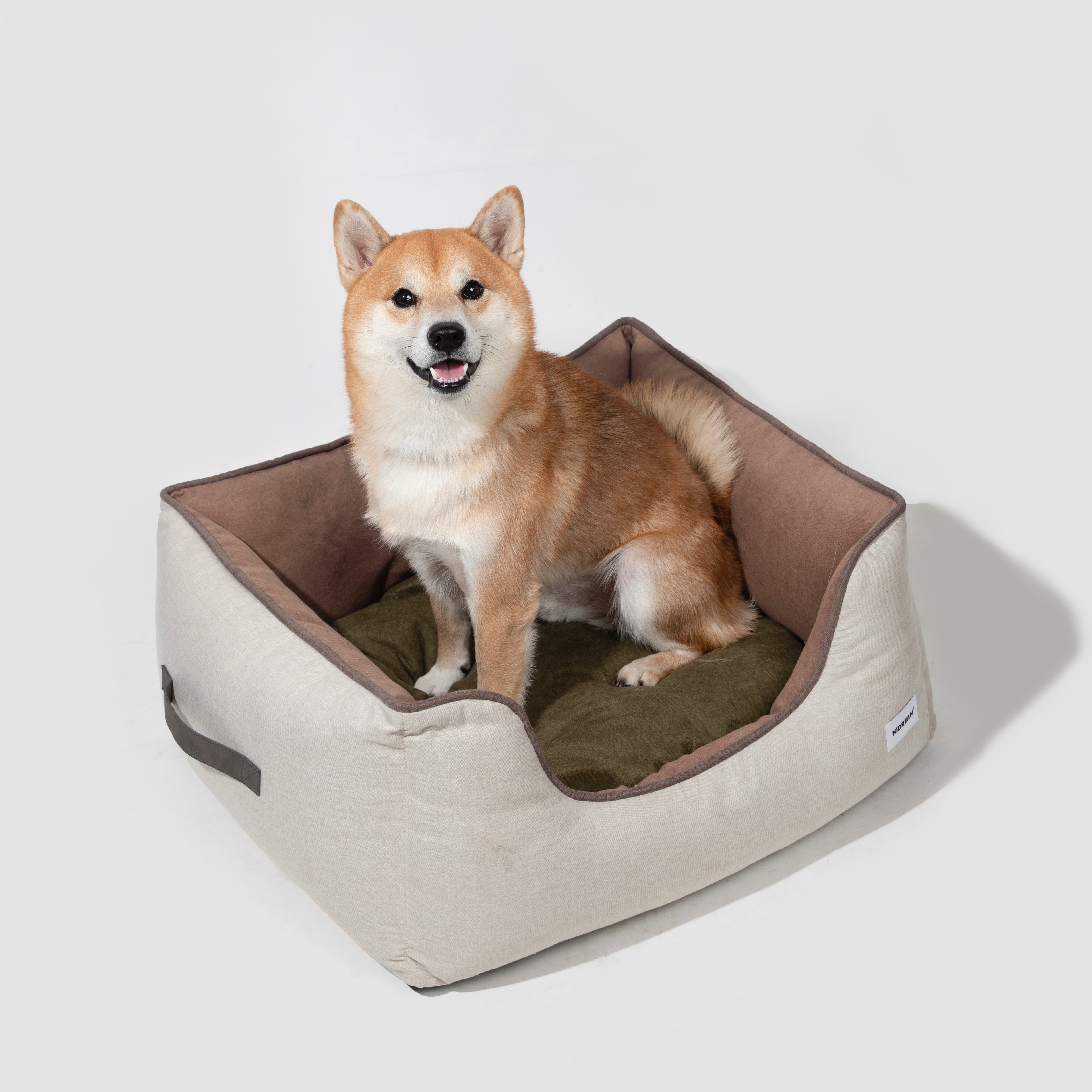 HiDREAM Four-Season Pet Bed with Shiba Inu on olive cushion. Spacious, washable nest with anti-slip base for dogs and cats.