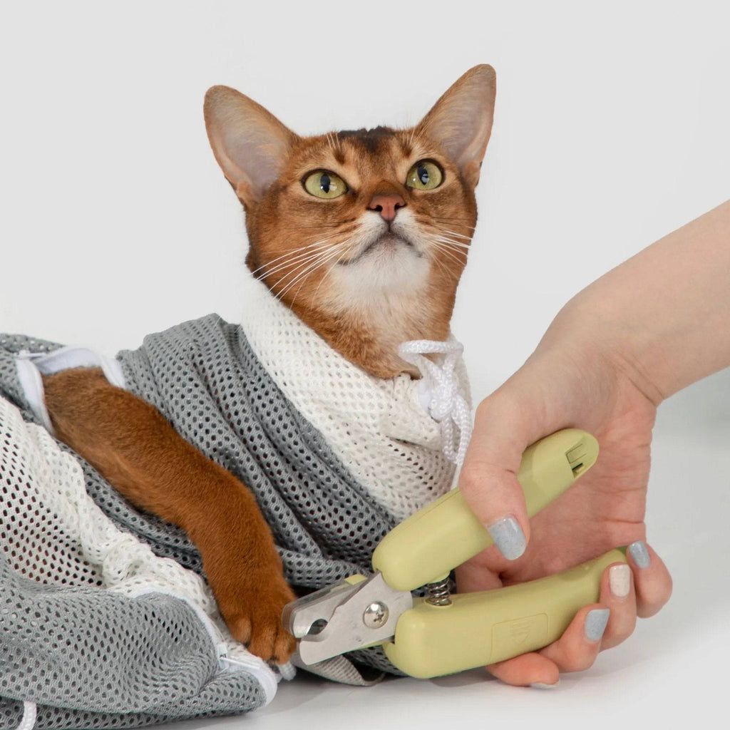 HiDREAM Cat Bathing Bag used while trimming a cat’s claws, ensuring safety and control during grooming.