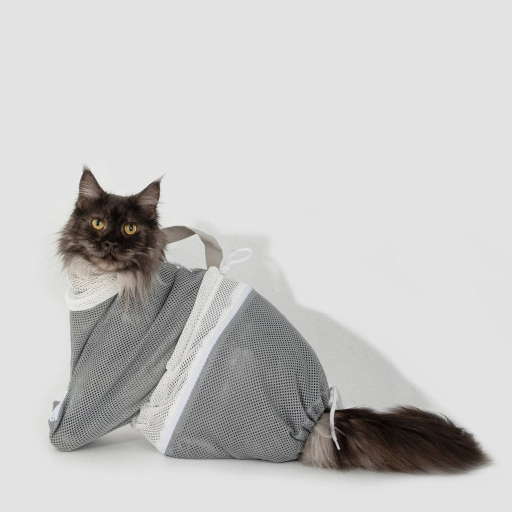 Long-haired cat sitting calmly in HiDREAM Cat Bathing Bag, showcasing mesh fit for all cat sizes and breeds.