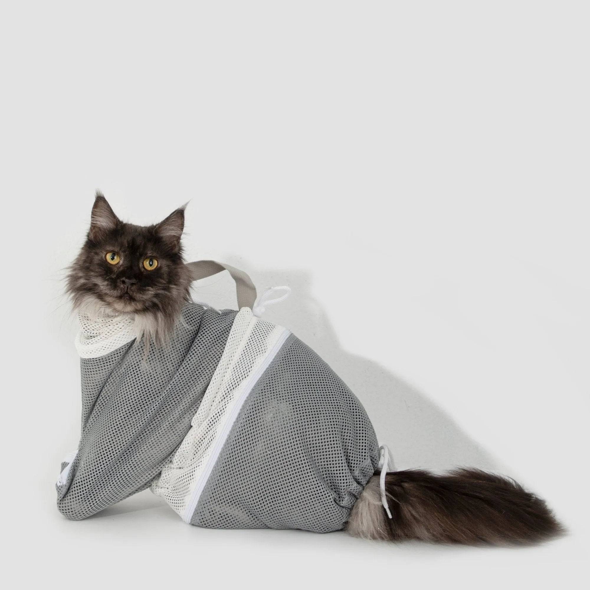 Long-haired cat sitting calmly in HiDREAM Cat Bathing Bag, showcasing mesh fit for all cat sizes and breeds.