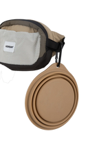 Side attachment loop on the dog walking belt bag holding a collapsible bowl