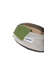 Dog waste bag stored in the flexible front pocket of the waist bag