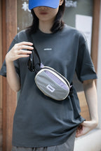 Dusk Mauve crossbody dog walking bag worn on an urban walk