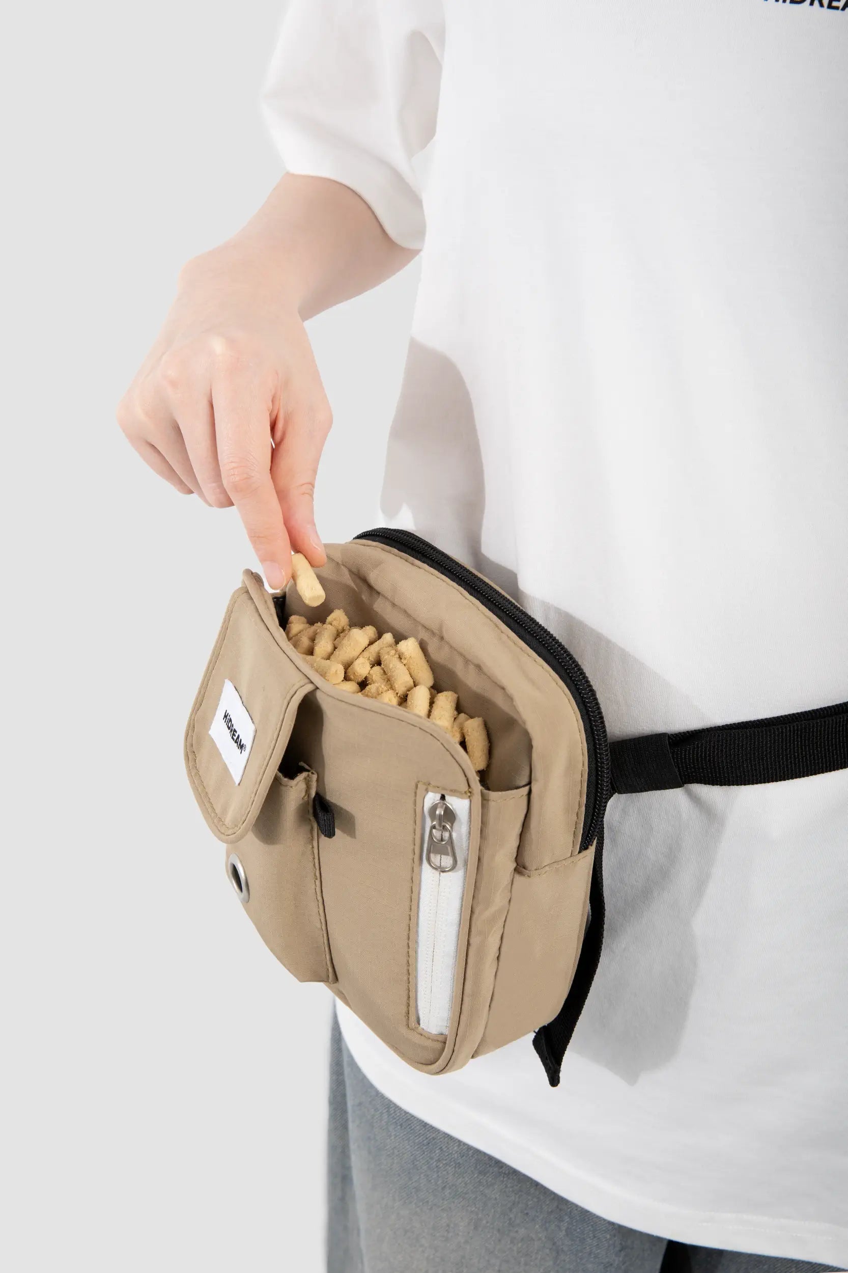 One-handed access to dog treats in the magnetic Terracotta Brown training pouch