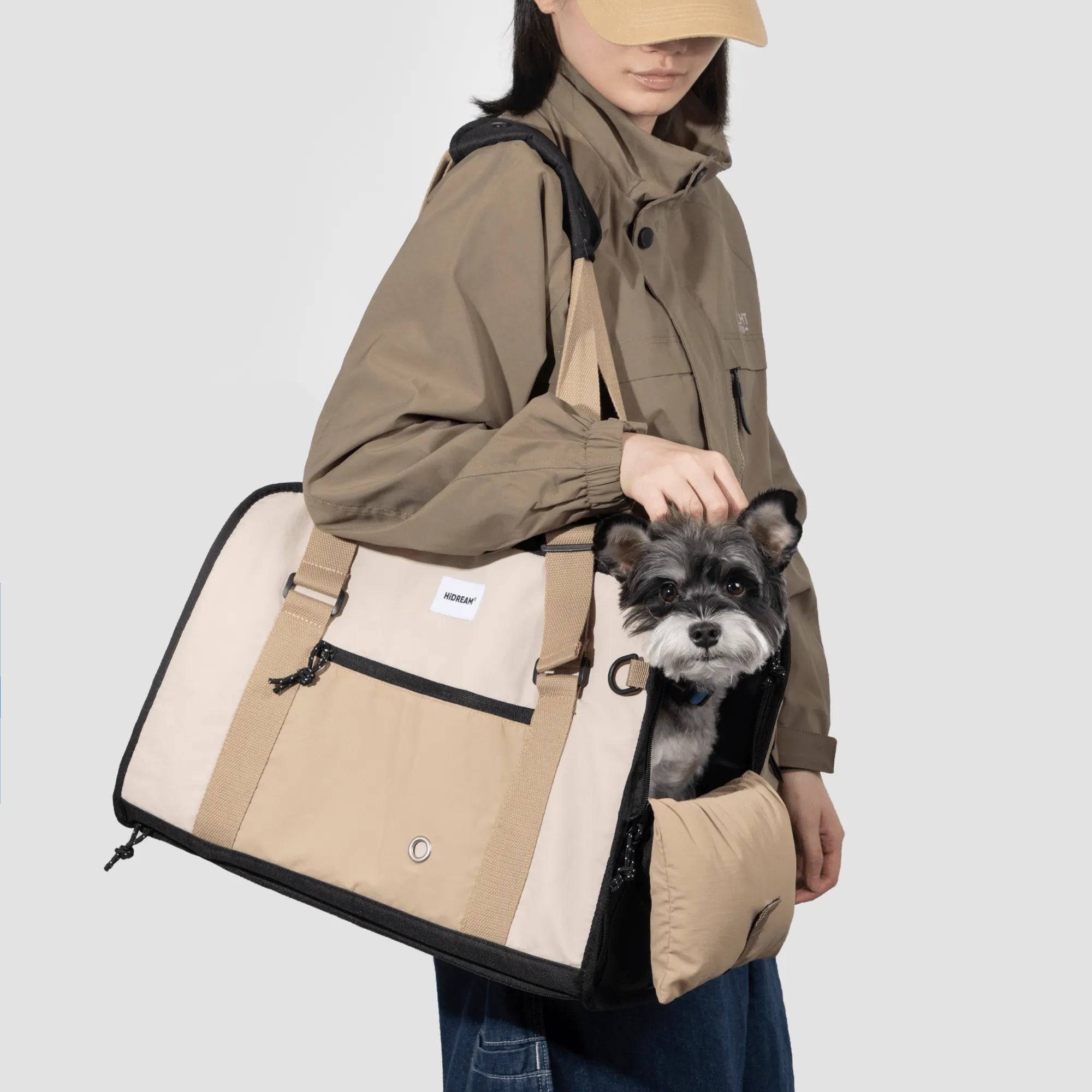 Dog inside beige HiDREAM 3-in-1 Sling Carrier, worn crossbody for stylish pet travel. Ideal for small pets and hands-free mobility in Australia.