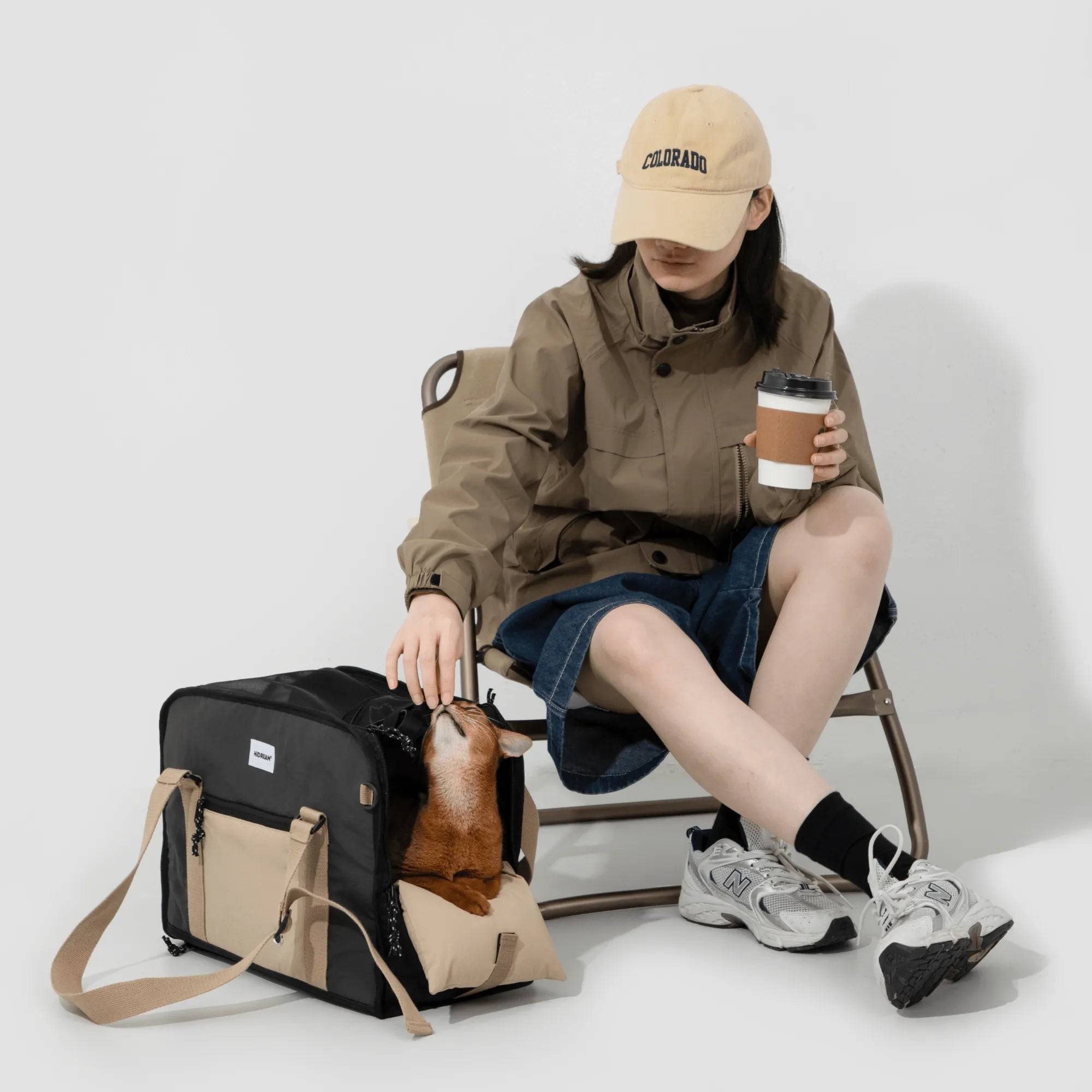 Woman petting dog inside HiDREAM Semi-open Papoose Bag, a 3-in-1 sling carrier for stylish pet travel. Perfect for outdoor adventures in Australia.