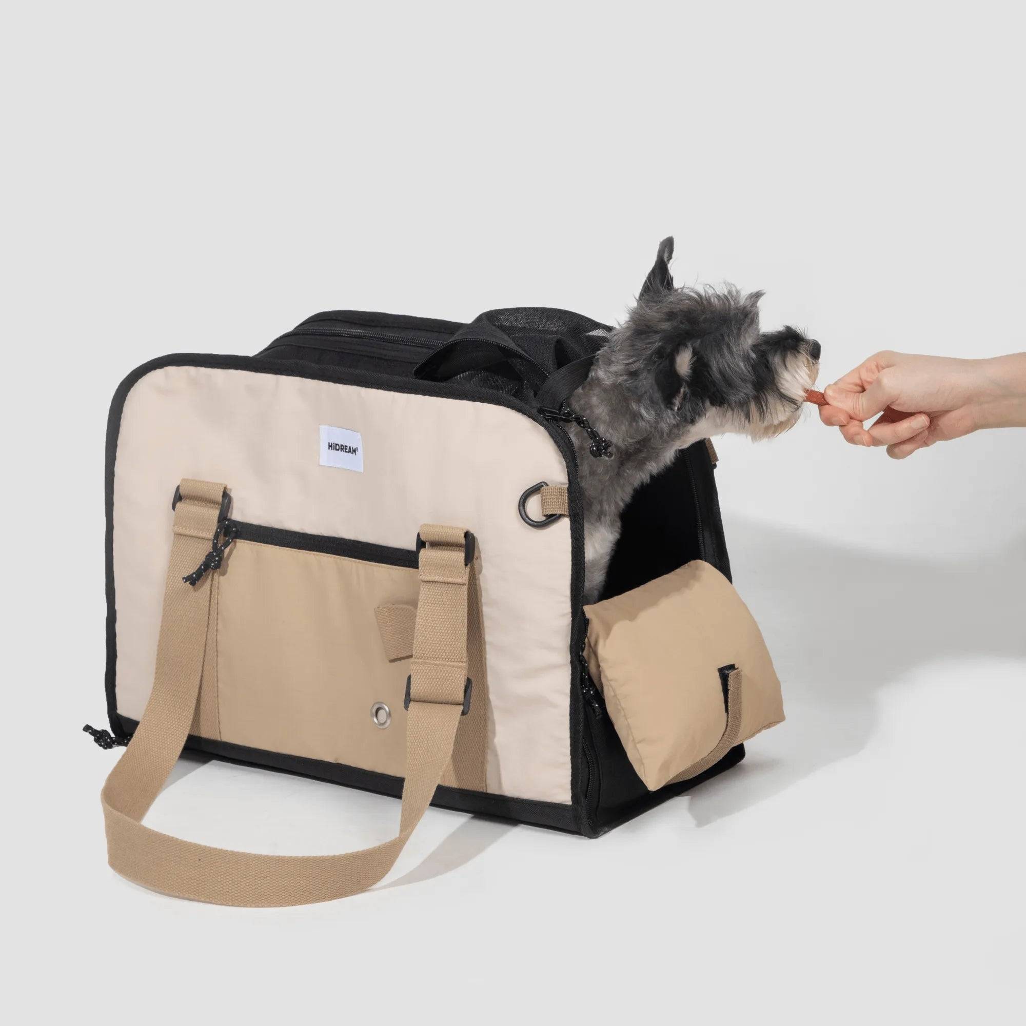 Dog being fed while sitting in HiDREAM Semi-open Papoose Bag. A 3-in-1 sling carrier for stylish and convenient pet travel in Australia.