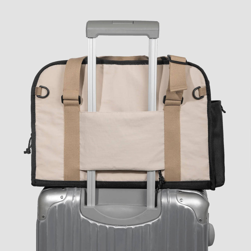 HiDREAM Sling Pet Carrier secured on suitcase handle. A 3-in-1 papoose bag designed for stylish and easy pet travel in Australia.