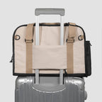 HiDREAM Sling Pet Carrier secured on suitcase handle. A 3-in-1 papoose bag designed for stylish and easy pet travel in Australia.